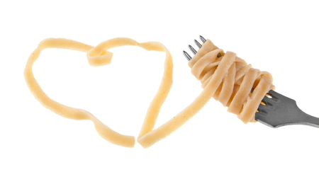 spaghetti on a fork isolated on a white backgroundの写真素材