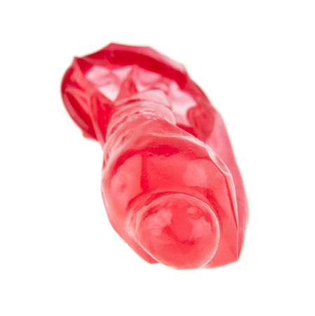 red condom isolated on white backgroundの写真素材