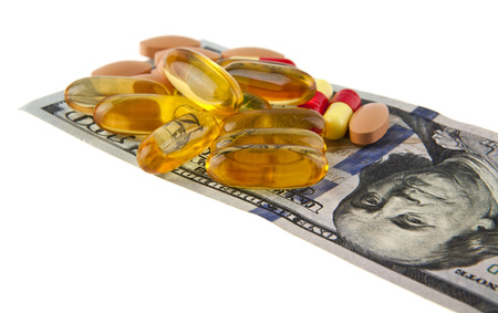 dollars and pills isolated on white background