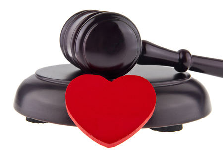 wooden hammer and red heart isolated on white backgroundの写真素材