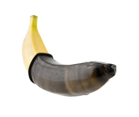 banana in condom isolated on white background, education conceptの写真素材