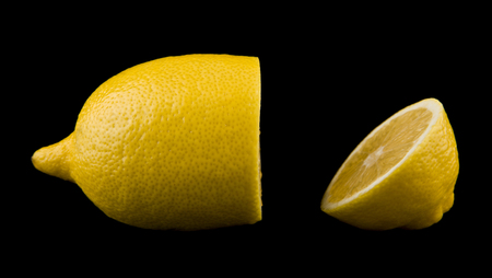 yellow juicy lemons isolated on a black backgroundの写真素材