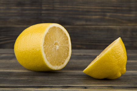 yellow juicy lemons on wooden backgroundの写真素材