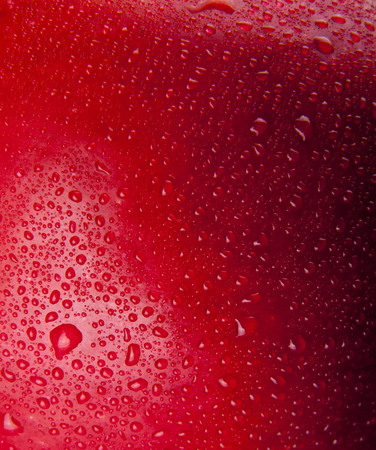 red background in drops of waterの写真素材