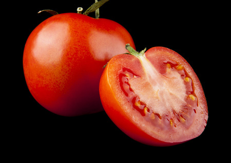 red and juicy tomatoes on a black backgroundの写真素材