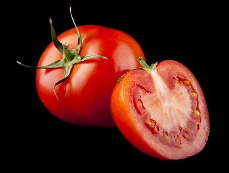 red and juicy tomatoes on a black backgroundの写真素材