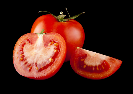 juicy, fresh red tomatoes on a black backgroundの写真素材