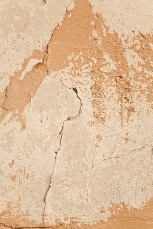 beige wall with a crack as a backgroundの写真素材
