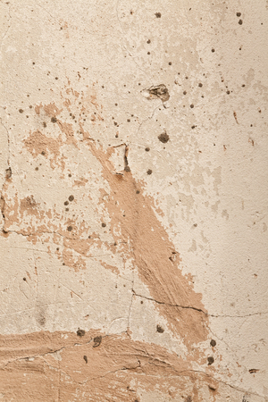 beige wall with a crack as a backgroundの写真素材