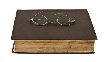 old book and glasses isolated on white backgroundの写真素材
