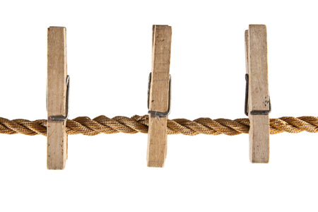 Wooden clothespins on a rope isolated on a white backgroundの写真素材