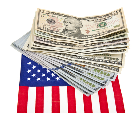 dollars and US flag isolated on white backgroundの写真素材