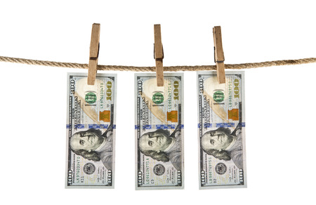 dollars with a clothespin on a rope isolated on a white backgroundの写真素材