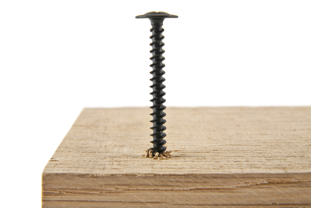 black screw screwed into a wooden bar isolated on white backgroundの写真素材