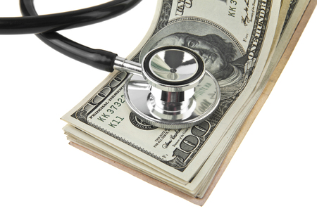 dollars and a stethoscope isolated on a white backgroundの写真素材