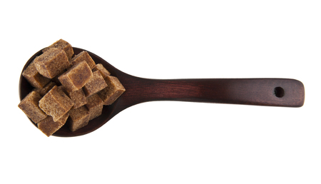 cane sugar in a wooden spoon isolated on a white backgroundの写真素材