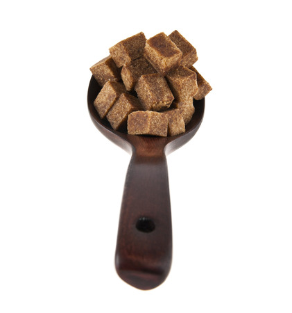 cane sugar in a wooden spoon isolated on a white backgroundの写真素材