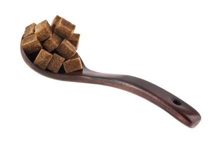 cane sugar in a wooden spoon isolated on a white backgroundの写真素材
