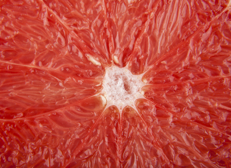 texture of a cut of a greyfruit as a backgroundの写真素材