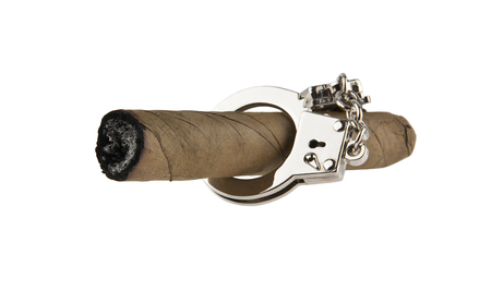 cigar in handcuffs isolated on white backgroundの写真素材