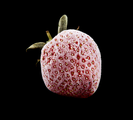 frozen strawberries isolated on a black backgroundの写真素材