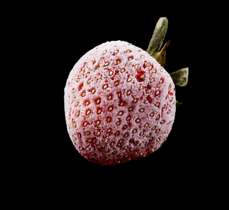 frozen strawberries isolated on a black backgroundの写真素材