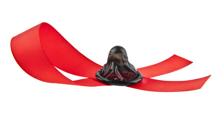 red tape and condom isolated on white background close-upの写真素材