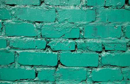 Old green brick wall as a background close-upの写真素材
