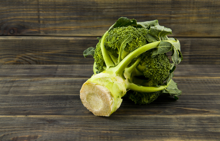 Raw green broccoli on wooden backgroundの写真素材