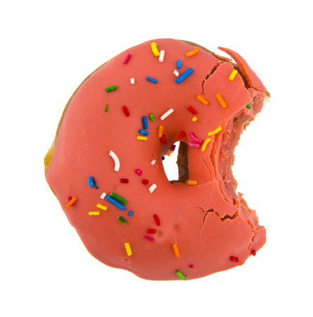 pink iced donut isolated on white backgroundの写真素材