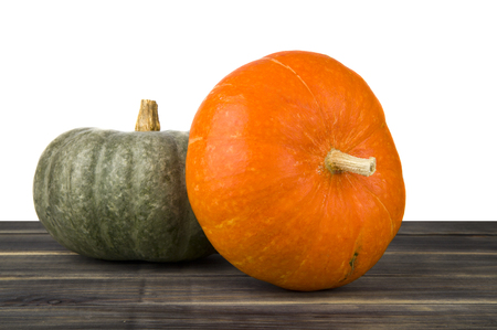 raw pumpkin on wooden table isolated on white backgroundの写真素材