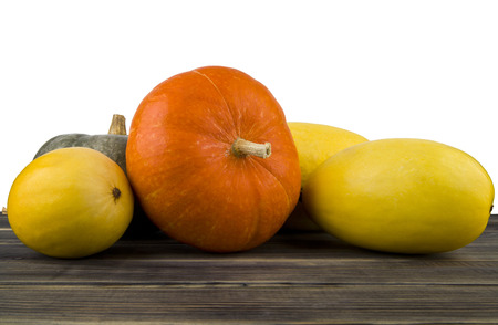 raw pumpkin on wooden table isolated on white backgroundの写真素材