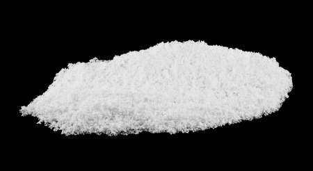 pile of white snow isolated on black backgroundの写真素材