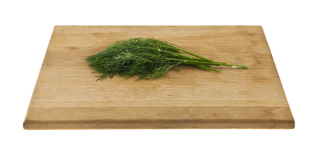 Dill on a wooden board isolated on whiteの写真素材