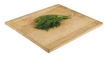 Dill on a wooden board isolated on whiteの写真素材
