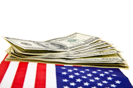 dollars and USA flag isolated on white backgroundの写真素材