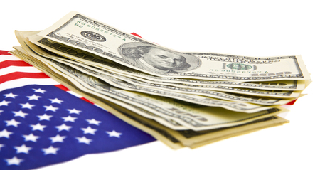 dollars and USA flag isolated on white backgroundの写真素材
