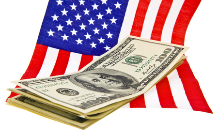 dollars and USA flag isolated on white backgroundの写真素材