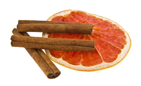 grapefruit and cinnamon isolated on white backgroundの写真素材