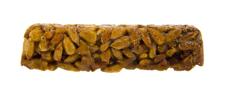 sunflower seeds in caramel isolated on white backgroundの写真素材