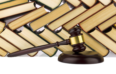 old hardcover books and wooden gavel isolated on white backgroundの写真素材