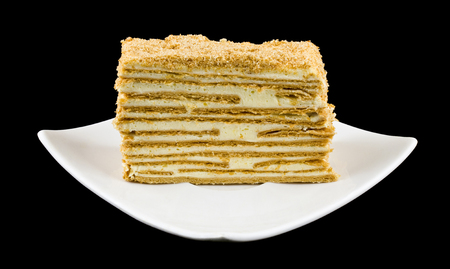 puff cake in a plate isolated on a black backgroundの写真素材