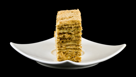 puff cake in a plate isolated on a black backgroundの写真素材