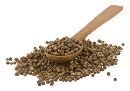 Coriander seeds in a wooden spoon Isolated on a white background.の写真素材
