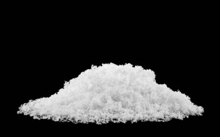 pile of fluffy white snow isolated on a black background.の写真素材