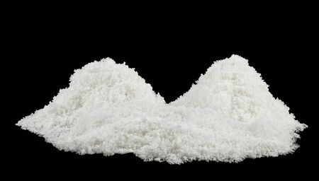 white snow isolated on black backgroundの写真素材