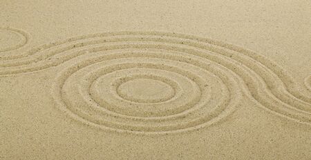 Zen drawing in the sand. The concept of harmony, balance and meditation, spa, relaxation. Abstract texture for background.の写真素材