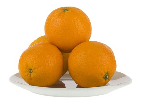 Oranges in a white plate isolated on a white background close-up.の写真素材