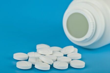 White tablets on a blue background close-up.の写真素材