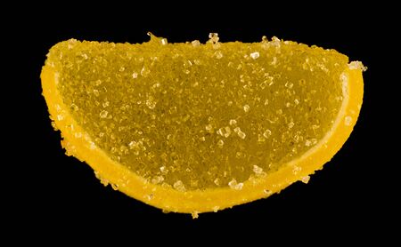 Marmalade slices isolated on a black background close-up.の写真素材